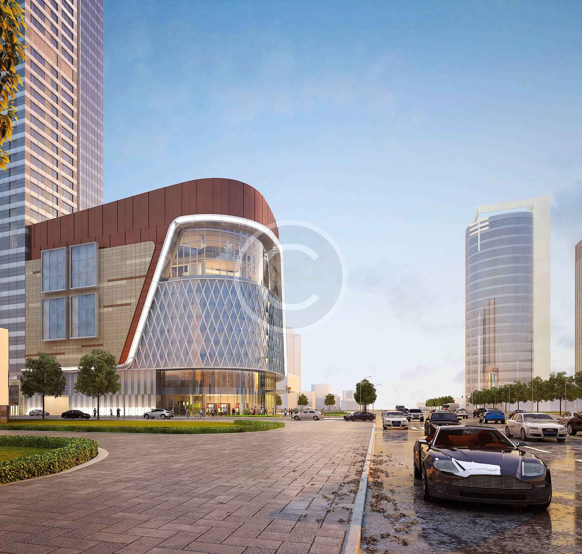 Calle de una ciudad moderna en la que se ve un edificio de cristal curvado, posiblemente de construcción prefabricada, con torres de gran altura al fondo y coches aparcados a lo largo de la calzada.